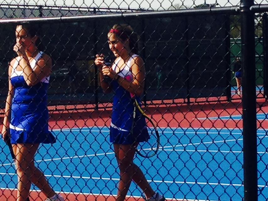 Senior Isabelle Gritsonis and junior Stephanie Jaster celebrate after winning their match.