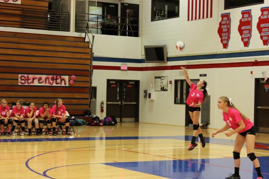 Sophomore Claire Werner serves as teammate senior Lydia Schlaefke prepares for the point. 