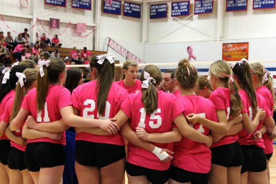 The team prepares for its annual Volley for the Cure match against Wheaton Academy. 