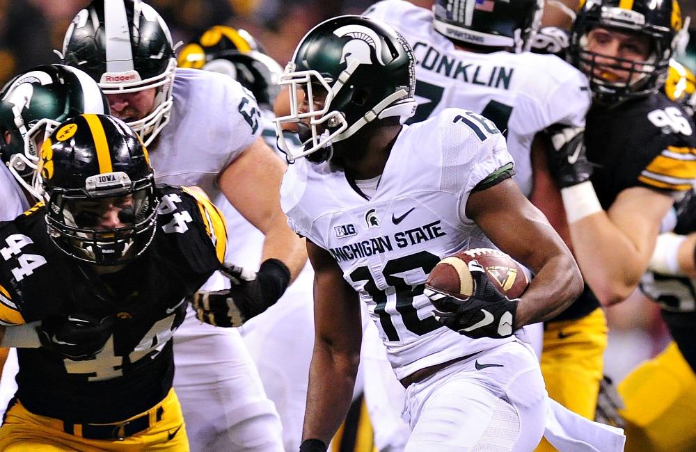 Dec 5, 2015; Indianapolis, IN, USA; Michigan State Spartans wide receiver Aaron Burbridge (16) runs the ball as Iowa Hawkeyes linebacker Ben Niemann (44) looks to defend during the first half in the Big Ten Conference football championship game at Lucas Oil Stadium. Mandatory Credit: Thomas J. Russo-USA TODAY Sports