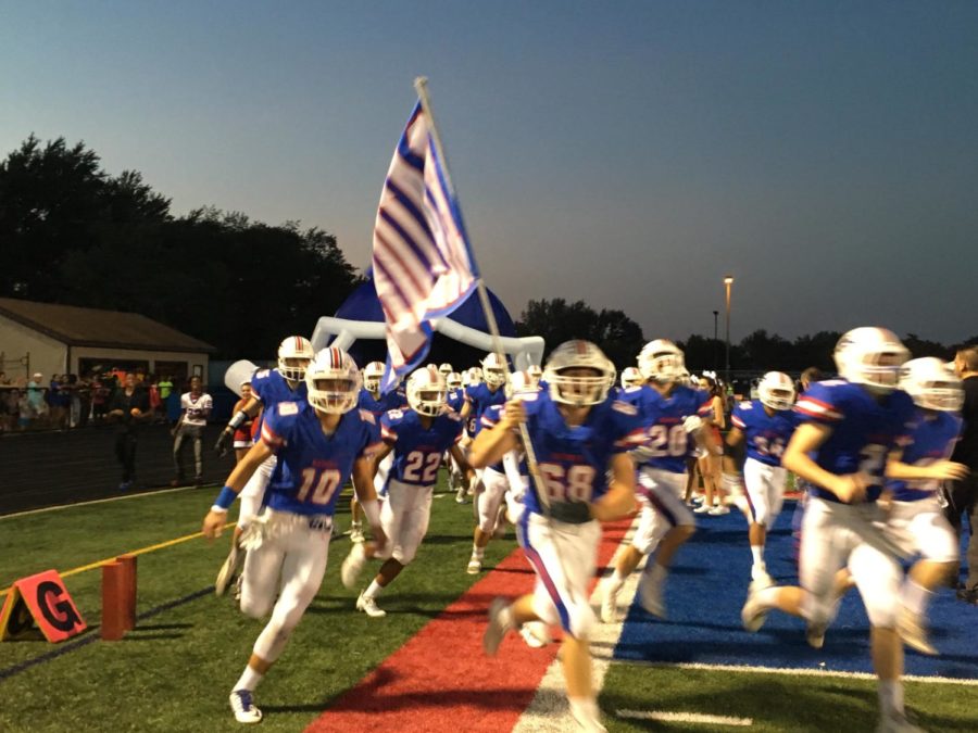 The Raiders Run onto the field before a September 22 game against Fenton at Glenbard South High School. 