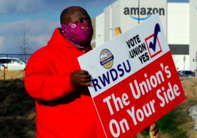 Michael Foster of the Retail, Wholesale and Department Store Union holds a sign Feb. 9, 2021, outside an Amazon facility in Bessemer, Alabama. (AP News Photo/Jay Reeves, File)