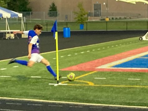 A member of the Raider boys soccer team prepares to make a corner kick.