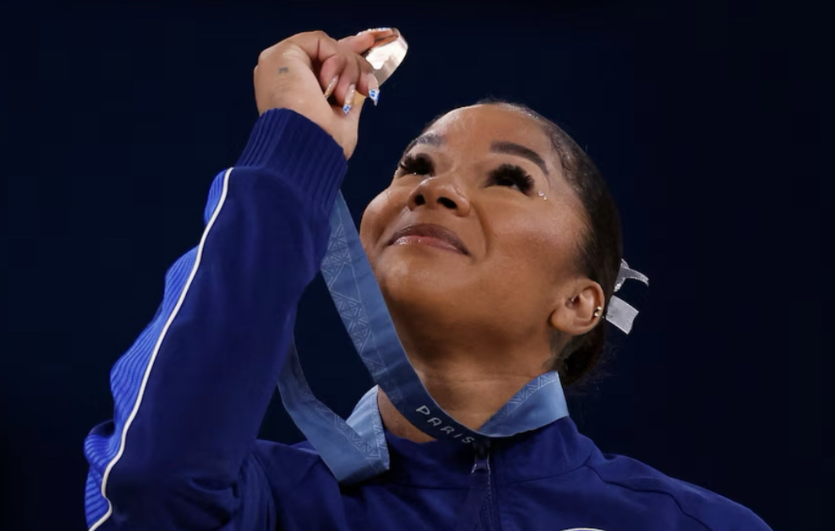 Jordan Chiles admiring her bronze medal after competing on floor at the 2024 Paris Olympics from ABC News
